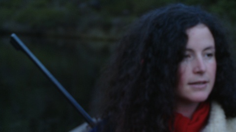 Woman on boat with gun