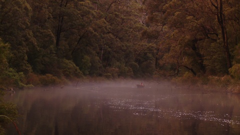 Woman disappearing into the river mist