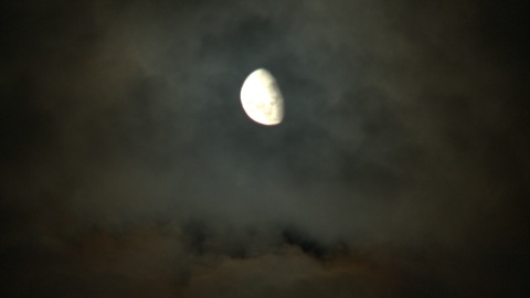 Moon on grey, cloudy sky